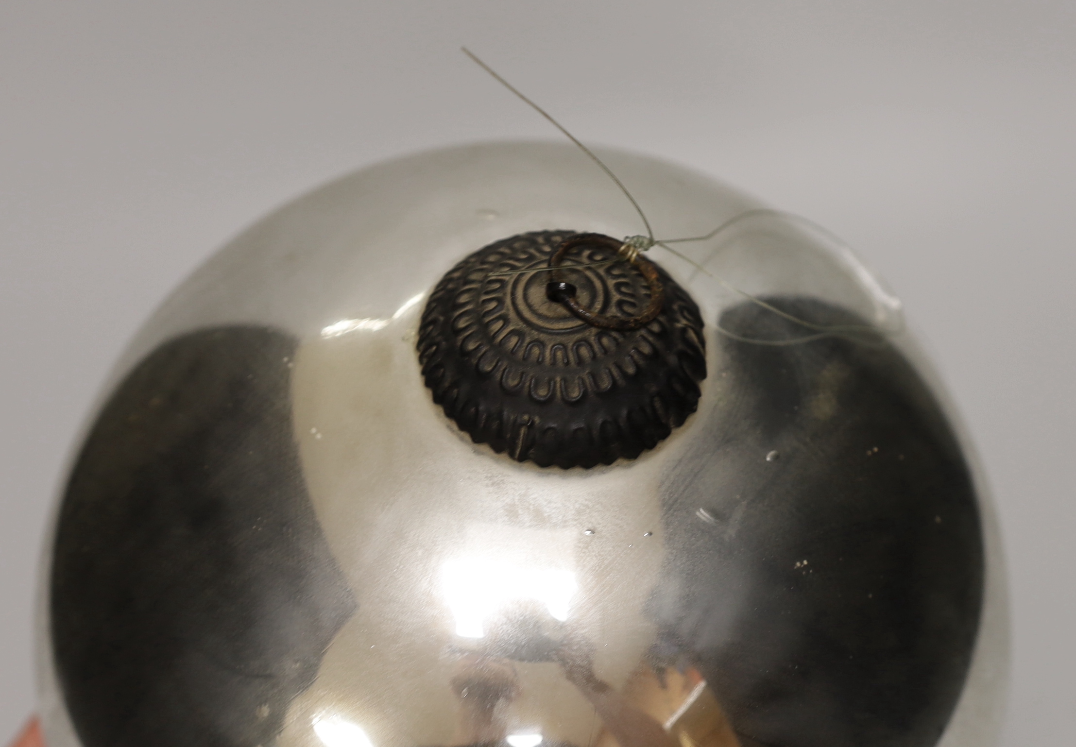 A Victorian silvered witch's ball and a smaller blue glass witch’s ball, the largest approximately 26cm in diameter